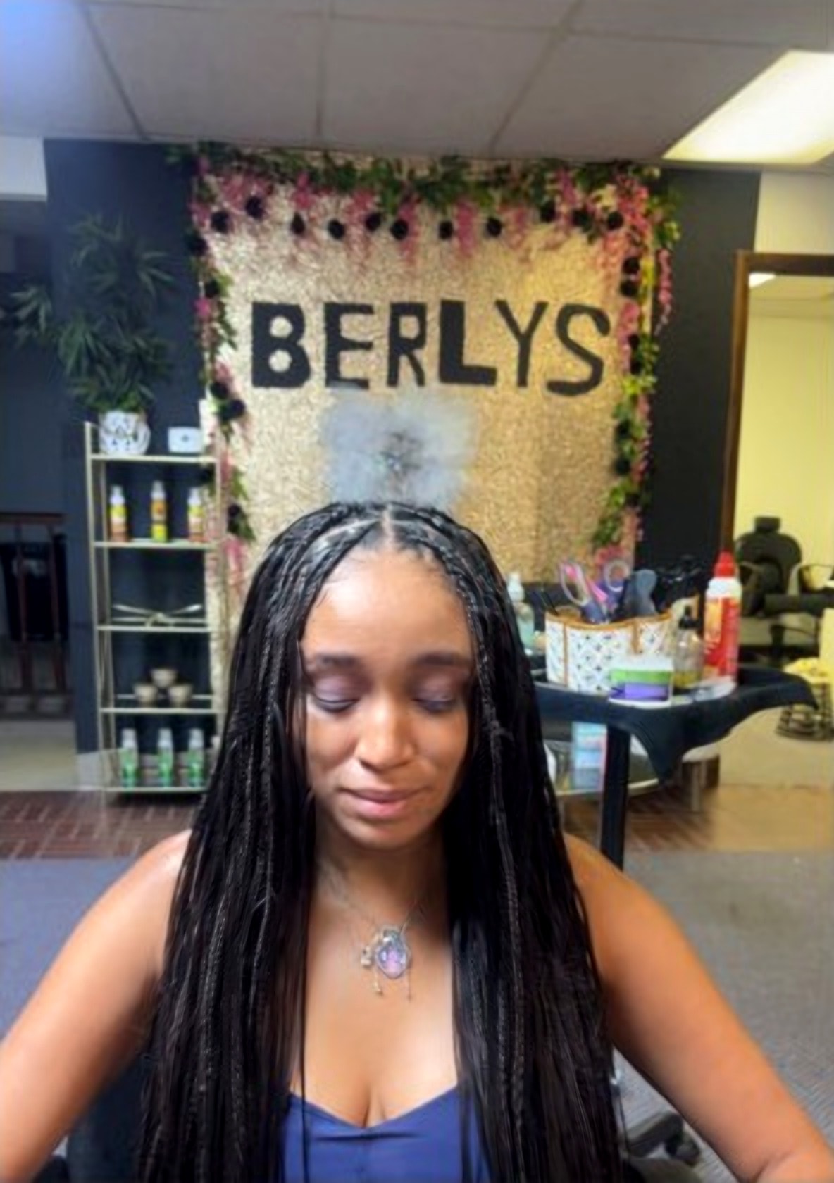 Boho straight black braids in front of the BERLYS gold salon backdrop, McKeesport PA